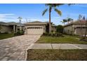 One-story house with a two-car garage and a brick paved driveway at 1531 Riverdale Dr, Oldsmar, FL 34677