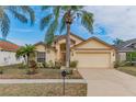 Charming single-story house with a large front yard and palm trees at 1706 Kirtley Dr, Brandon, FL 33511