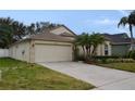 One story house with a two-car garage and manicured lawn at 18916 New Passage Blvd, Land O Lakes, FL 34638