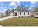 Newly built home with a white exterior and gray roof at 2549 Martha Ln, Land O Lakes, FL 34639