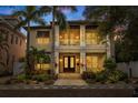 Two-story house with double front doors, landscaping, and walkway at night at 310 8Th N Ave, St Petersburg, FL 33701