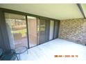 Covered patio with sliding glass doors leading to interior at 36750 Us Highway 19 N # 23120, Palm Harbor, FL 34684