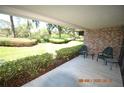 Brick patio with chairs and view of the green space at 36750 Us Highway 19 N # 23120, Palm Harbor, FL 34684