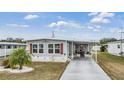 Front view of a single-wide manufactured home with landscaping at 36905 Beth Ave, Zephyrhills, FL 33542