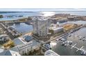 High-rise building with water and city views, surrounded by lush landscaping at 5120 Marina Way # 2205, Tampa, FL 33611