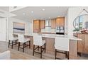 Modern kitchen with island, stainless steel appliances, and hardwood floors at 5120 Marina Way # 2205, Tampa, FL 33611