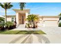 Single-story home with a light-colored exterior and a welcoming front porch at 705 Pinckney Dr, Apollo Beach, FL 33572