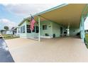 Front view of a light green manufactured home at 7050 El Matador St, Zephyrhills, FL 33541