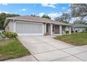 Ranch home with a screened garage and a large driveway at 8130 Merrimac Dr, Port Richey, FL 34668