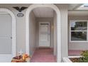 Front entry with arched entryway, and decorative urns at 8130 Merrimac Dr, Port Richey, FL 34668