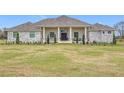 Beautiful two-story home with stone exterior and landscaping at 8459 Harvey Walden Dr, Plant City, FL 33565