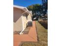 Side yard with freshly painted walkway and AC unit at 10202 Oak Hill Dr, Port Richey, FL 34668