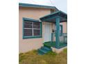 Teal-trimmed porch and entrance to a tan house at 1106 Carlton St, Clearwater, FL 33755