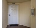 Condo building entry with white door and mat at 1200 Country Club Dr # 6206, Largo, FL 33771