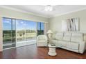 Living room with hardwood floors and sliding glass doors at 1200 Country Club Dr # 6206, Largo, FL 33771