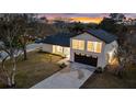 Nighttime aerial view highlights the home's curb appeal and unique architecture at 12413 Gunstock Ln, Hudson, FL 34667