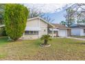 Well-maintained ranch house with a lush green lawn at 12512 River Mill Dr, Hudson, FL 34667