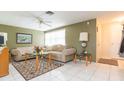 Bright living room featuring a comfy sectional sofa and tiled floors at 12512 River Mill Dr, Hudson, FL 34667