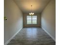 Formal dining area with chandelier and large window at 13251 Ogden Glade Rd, Dade City, FL 33525