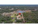 Aerial view showcasing house, expansive lot, and surrounding landscape at 18010 Okeene Dr, Hudson, FL 34667