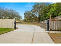 Long driveway leading to the house with gated entrance at 18010 Okeene Dr, Hudson, FL 34667