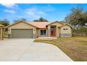 Single-story home with attached garage, copper roof, and stone accents at 18010 Okeene Dr, Hudson, FL 34667