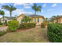 House exterior showcasing a well-maintained lawn and tropical landscaping at 1933 Sterling Glen Ct, Sun City Center, FL 33573