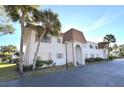 Front view of a two-story building with a brown roof and a landscaped area at 207 S Mcmullen Booth Rd # 198, Clearwater, FL 33759