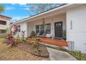 Welcoming front porch with red tile and landscaping at 2504 W Fletcher Ave, Tampa, FL 33618