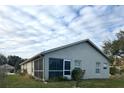 Rear view of a single story house with screened enclosure at 276 Rochester St, Spring Hill, FL 34609