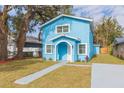 Newly built light blue house with a walkway and small yard at 3630 E North Bay St, Tampa, FL 33610