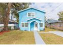 Newly built light blue house with a walkway and small yard at 3630 E North Bay St, Tampa, FL 33610