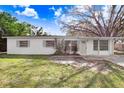 Cozy single-story home featuring a classic design and a neatly kept front yard, perfect for suburban living at 504 Holly Ln, Brandon, FL 33510