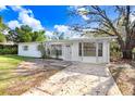 Inviting single-story home with a well-lit entrance, large windows, and a concrete driveway at 504 Holly Ln, Brandon, FL 33510