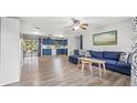 Open living room with blue couch and kitchen view at 5243 27Th N Ave, St Petersburg, FL 33710