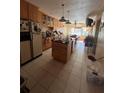 View of the home's kitchen with tile flooring and center island at 530 62Nd S Ave, St Petersburg, FL 33704