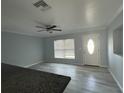 Living room with gray walls, wood-look floors, and an open kitchen concept at 5352 Tangerine Dr, New Port Richey, FL 34652