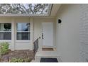 Front entrance with white door and decorative detailing at 553 Lake Hill Ln, Largo, FL 33771