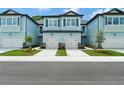 Front view of two attached townhouses with light blue siding, gray roofs, and two-car garages at 7773 93Rd N St # 31, Seminole, FL 33777