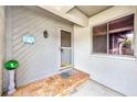 Inviting condo entryway with tiled flooring and a charming welcome sign at 90 S Highland Ave # 7, Tarpon Springs, FL 34689