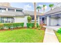 Inviting home exterior featuring well-maintained landscaping, a manicured lawn, and a welcoming entrance at 90 S Highland Ave # 7, Tarpon Springs, FL 34689