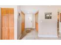 Bright hallway with wood-trimmed closets and a decorative floor medallion at 90 S Highland Ave # 7, Tarpon Springs, FL 34689