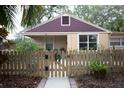 Charming house with a picket fence and landscaping at 1018 E Hanna Ave, Tampa, FL 33604