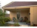 Relaxing front porch with seating and potted plants at 1018 E Hanna Ave, Tampa, FL 33604