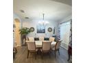 Elegant dining room with oval table and chandelier at 10537 Sky Flower Ct, Land O Lakes, FL 34638