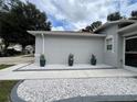 Well-maintained exterior with landscaped walkway and plants at 11719 Mango Groves Blvd, Seffner, FL 33584