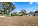 Ranch-style home with a large yard and driveway at 13000 Club Dr, Hudson, FL 34667