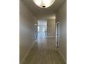 Bright hallway with tile floors and views into the living area at 13299 Ogden Glade Rd, Dade City, FL 33525