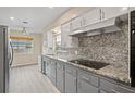 Gray kitchen with granite countertops and stainless steel appliances at 1338 Whitacre Dr, Clearwater, FL 33764