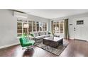 Living room with grey sofa, green chair, and hardwood floors at 1437 Park St, Clearwater, FL 33755